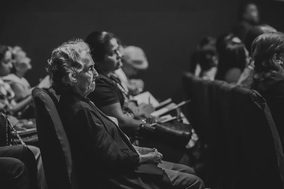 An audience seated in a hall, watching a live event