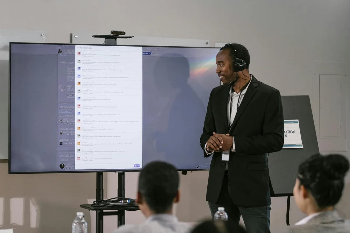 Presenter with a headset microphone in front of a screen - multi-language live audio on dcast and other platforms